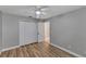 Bedroom with wood-look floors, closet, and neutral walls at 9729 Bay Colony Dr, Riverview, FL 33578