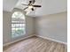 Comfortable bedroom with vaulted ceiling, large window, and wood-look floors at 9729 Bay Colony Dr, Riverview, FL 33578