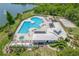 Aerial view of the community pool and clubhouse, showcasing amenities including a pool, spa, and lounge areas at 9729 Bay Colony Dr, Riverview, FL 33578