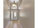Inviting foyer with high ceilings, tile floors, and a decorative front door at 9729 Bay Colony Dr, Riverview, FL 33578