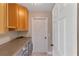 Functional laundry room with washer, dryer, storage cabinets, and a door at 9729 Bay Colony Dr, Riverview, FL 33578