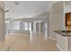 Open-concept living room with tile flooring, high ceilings, and neutral paint at 9729 Bay Colony Dr, Riverview, FL 33578