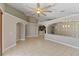 Spacious living room with tile floors, archways, and modern lighting fixtures at 9729 Bay Colony Dr, Riverview, FL 33578