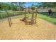 Brightly colored playground on a wood chip base with monkey bars, slide, and climbing apparatus at 9729 Bay Colony Dr, Riverview, FL 33578