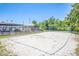 Community volleyball court with sand and net, surrounded by trees and blue skies at 9729 Bay Colony Dr, Riverview, FL 33578
