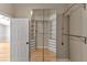 Spacious walk-in closet with mirrored doors and custom shelving and drawers at 9729 Bay Colony Dr, Riverview, FL 33578