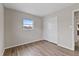 Bedroom featuring wood floors, a large window, and a spacious closet at 9744 Rainelle Ln, Port Richey, FL 34668