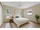 Bright bedroom with a ceiling fan, wood floors, and lots of natural light at 9744 Rainelle Ln, Port Richey, FL 34668