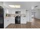Modern kitchen with white cabinets, updated appliances, and ample counter space at 9744 Rainelle Ln, Port Richey, FL 34668