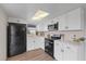 Bright kitchen featuring modern white cabinets and stainless steel appliances at 9744 Rainelle Ln, Port Richey, FL 34668