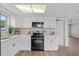 Bright kitchen featuring modern white cabinets, and stainless steel appliances at 9744 Rainelle Ln, Port Richey, FL 34668