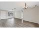 Large living room featuring hardwood floors, ceiling fan, chandelier, and natural light at 9744 Rainelle Ln, Port Richey, FL 34668