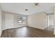 Open-concept living room with wood floors, front door, and neutral paint that brightens the space at 9744 Rainelle Ln, Port Richey, FL 34668