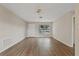 Large living room with wood floors, ceiling fan, and lots of natural light at 9744 Rainelle Ln, Port Richey, FL 34668