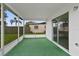 Covered patio with screens and sliding glass doors, overlooking the backyard at 9744 Rainelle Ln, Port Richey, FL 34668