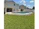 Private pool features a large deck, a lush grassy area, and a white privacy fence, creating a backyard oasis at 9808 Riverchase Dr, New Port Richey, FL 34655