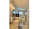 Modern bathroom featuring a single sink vanity, tiled floors, soaking tub with tile surround and glass-enclosed shower at 9808 Riverchase Dr, New Port Richey, FL 34655