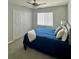 Comfortable bedroom with a ceiling fan, double closet and a window with blinds for natural light at 9808 Riverchase Dr, New Port Richey, FL 34655