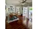 Bright dining area featuring wood floors, modern ceiling fan, and sliding glass doors at 9808 Riverchase Dr, New Port Richey, FL 34655