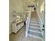 Inviting entryway with neutral tones, tiled floors, a decorative console table, and staircase to the upper level at 9808 Riverchase Dr, New Port Richey, FL 34655