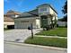 Well-maintained two-story home featuring a lovely landscaped yard and an extended paver driveway at 9808 Riverchase Dr, New Port Richey, FL 34655