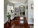 Inviting hallway with wood floors and neutral walls leading to the main entrance at 9808 Riverchase Dr, New Port Richey, FL 34655