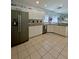 Modern kitchen featuring stainless steel appliances, white cabinets, and tile floors at 9808 Riverchase Dr, New Port Richey, FL 34655