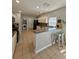 Well-designed kitchen featuring a breakfast bar, stainless steel appliances, and a laundry area at 9808 Riverchase Dr, New Port Richey, FL 34655