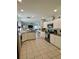 Bright, well-equipped kitchen with ample counter space, stainless steel appliances, and tile flooring at 9808 Riverchase Dr, New Port Richey, FL 34655
