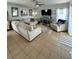 Bright living room featuring tile floors, neutral walls, ceiling fan, and comfortable seating at 9808 Riverchase Dr, New Port Richey, FL 34655