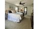 Cozy main bedroom with neutral walls, plush carpet, and a comfortable bed with stylish bedding at 9808 Riverchase Dr, New Port Richey, FL 34655
