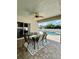 Covered patio features a dining table with seating for six, ceiling fan, and access to a private pool area at 9808 Riverchase Dr, New Port Richey, FL 34655