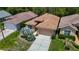 Scenic aerial view of a residential home with manicured lawns and lush landscaping at 10181 Holly Berry Dr, Weeki Wachee, FL 34613