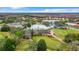 Aerial view of the clubhouse, golf course, pool, and tennis courts in a lovely community at 10181 Holly Berry Dr, Weeki Wachee, FL 34613