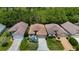 Aerial view of three homes with mature landscaping and a dense tree line in the background at 10181 Holly Berry Dr, Weeki Wachee, FL 34613