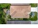 Birds-eye view of the property highlighting roof, driveway, landscaping, and screened patio at 10181 Holly Berry Dr, Weeki Wachee, FL 34613