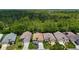 Overhead view of homes in a tranquil, wooded neighborhood, with lush green trees as a backdrop at 10181 Holly Berry Dr, Weeki Wachee, FL 34613