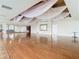 Open ballroom space with hardwood floors, decorative ceiling draping and ample room for large gatherings and special events at 10181 Holly Berry Dr, Weeki Wachee, FL 34613