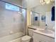 Bathroom highlighting a glass-enclosed shower, vanity with sink, and a bright window for natural light at 10181 Holly Berry Dr, Weeki Wachee, FL 34613