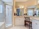 Bright bathroom featuring vanity with ample countertop, a glass shower, and multiple mirrors at 10181 Holly Berry Dr, Weeki Wachee, FL 34613