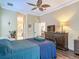 Bright bedroom with a view of the bathroom, stylish dresser, and comfortable bed, all tied together by natural light at 10181 Holly Berry Dr, Weeki Wachee, FL 34613