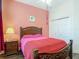 Charming bedroom with a decorative bed frame, ceiling fan, and an adjacent closet for ample storage at 10181 Holly Berry Dr, Weeki Wachee, FL 34613