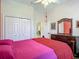 Bedroom featuring a spacious closet, wooden dresser with mirror, and view into another room at 10181 Holly Berry Dr, Weeki Wachee, FL 34613