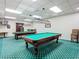 Spacious billiard room featuring two pool tables with overhead lighting for enhanced play at 10181 Holly Berry Dr, Weeki Wachee, FL 34613