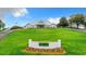 Beautifully landscaped clubhouse entrance with manicured lawn and elegant signage at 10181 Holly Berry Dr, Weeki Wachee, FL 34613