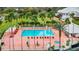 Expansive community pool area surrounded by palm trees, lounge chairs, and lush landscaping at 10181 Holly Berry Dr, Weeki Wachee, FL 34613