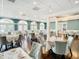 Spacious dining room with tables set for service, hardwood floors and teal walls at 10181 Holly Berry Dr, Weeki Wachee, FL 34613