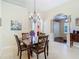 Inviting dining room features tile floors, archways, modern chandelier, and seamless flow to other living spaces at 10181 Holly Berry Dr, Weeki Wachee, FL 34613