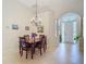 Inviting dining room features tile floors, archways, modern chandelier, and seamless flow to other living spaces at 10181 Holly Berry Dr, Weeki Wachee, FL 34613