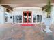 Elegant entrance with red double doors, potted plants, and patterned tile walkway at 10181 Holly Berry Dr, Weeki Wachee, FL 34613